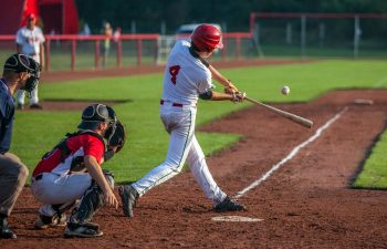 young baseball batter and catcher during the training